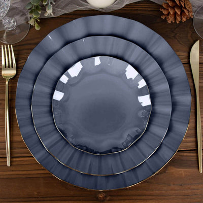 Elegant navy blue plates with gold trim stacked on a wooden table.