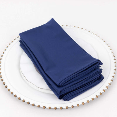 Navy blue napkins stacked on a decorative plate
