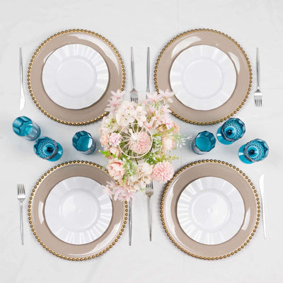Elegant dining table setup with plates, cutlery, and floral centerpiece.