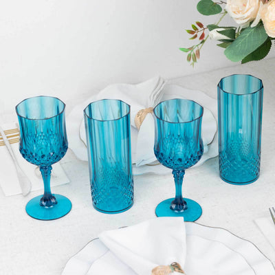 Set of four elegant blue glassware pieces on a dining table.
