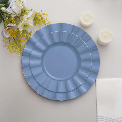 Blue decorative plates arranged with floral accents and candles.