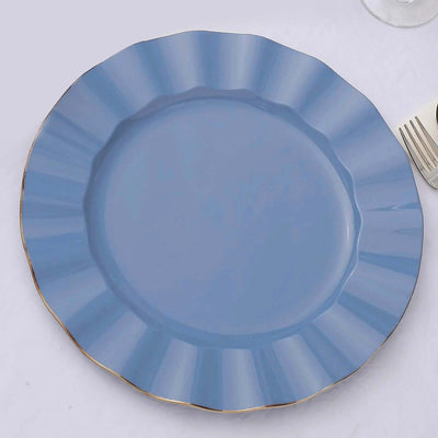 Blue scalloped dinner plate with gold rim on a plain background.