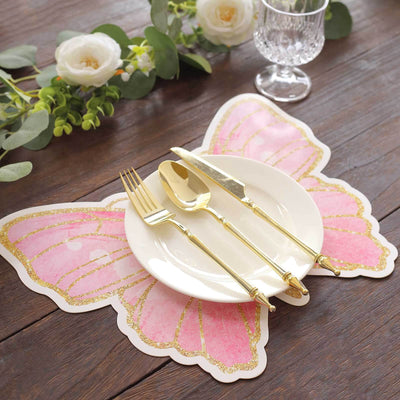 Butterfly-shaped placemat with gold utensils and a white plate, styled for dining.