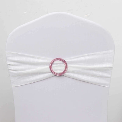 White chair cover with pink decorative belt and ring detail