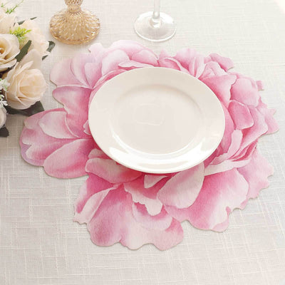 Pink floral placemat with a white plate on a textured table setting.