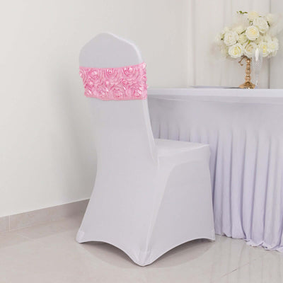 White chair cover with pink rose embellishment on a table setting.