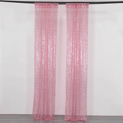 Pink sequin curtains hanging from a rod in a studio setting.