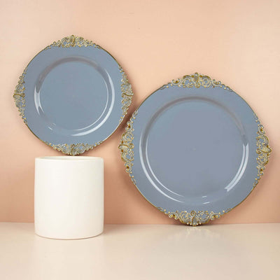 Elegant blue plates with ornate gold trim displayed on a modern pedestal.