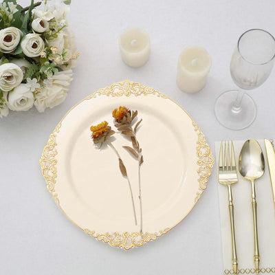 Elegant plate with dried flowers, gold accents, and dining utensils arranged beautifully.
