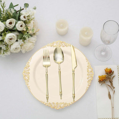 Elegant gold-accented cutlery set on a decorative plate with floral arrangement.