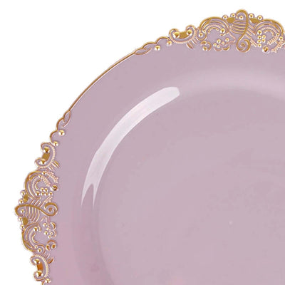 Pink plate with ornate gold trim on a white background.