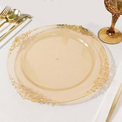 Elegant clear charger plate with gold embellishments on a white backdrop.