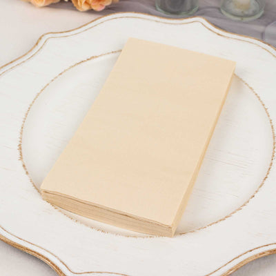 Beige paper sheets stacked on a decorative white plate.