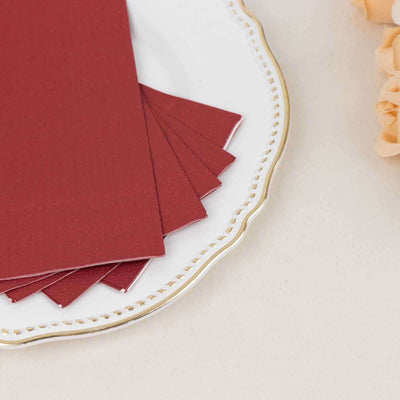 Burgundy color swatches on an elegant plate with floral accents.