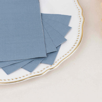 Blue textured cardstock sheets stacked on a decorative plate.