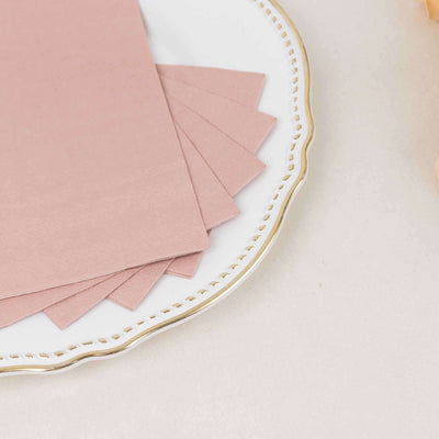 Pink paper sheets arranged on a decorative plate.