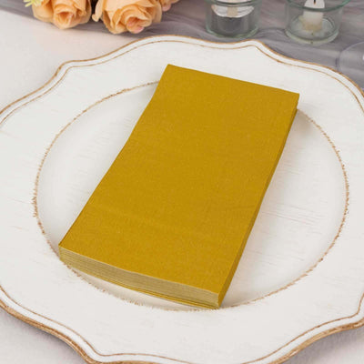 Pack of golden napkins on an elegant plate.