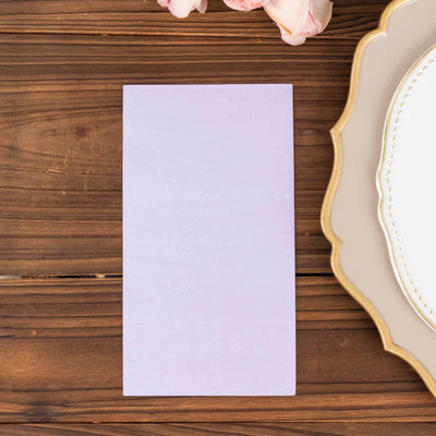 Lavender cardstock on a wooden table with a decorative plate and flowers.