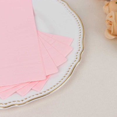 Pink paper sheets arranged on a decorative plate.