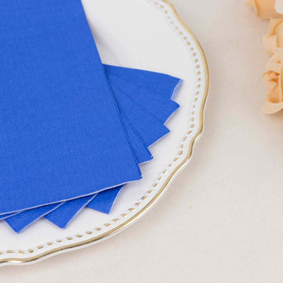 Blue cardstock sheets arranged on a decorative plate.