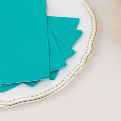Teal cardstock sheets on an elegant plate.
