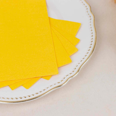 Yellow sheets of paper on a decorative white plate.