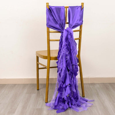 Purple satin chair sash with ruffled design draped on a gold chair.