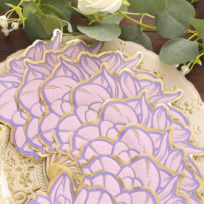 Purple floral paper coasters with gold accents on a decorative plate.