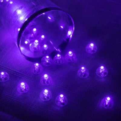 Purple LED lights scattered around a clear cup.