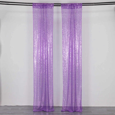 Purple sequin curtains hanging on a rod against a plain background.
