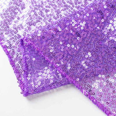 Purple sequin fabric with shimmering texture and vibrant color.
