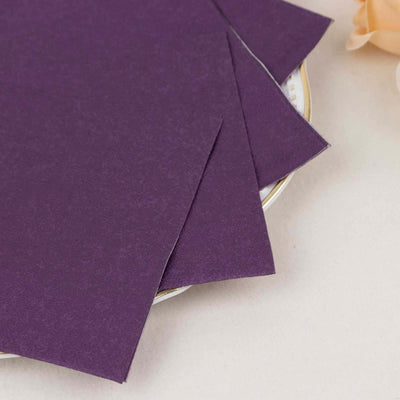 Purple craft paper sheets stacked on a plate.