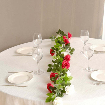 Elegant table setting with rose centerpiece and glassware.