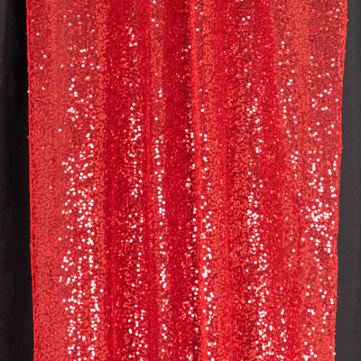Red sequin fabric drape for festive decorations or costumes.