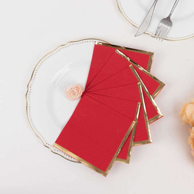 Red greeting cards with gold edges on a decorative plate.