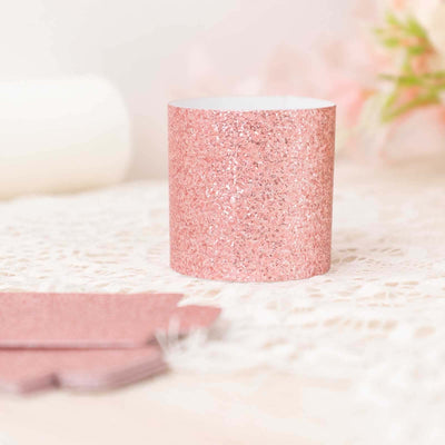 Pink glitter candle holder with a shiny finish against a soft background.