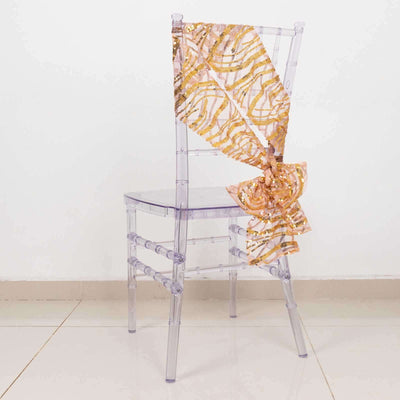 Clear acrylic chair with a decorative gold and pink ribbon.