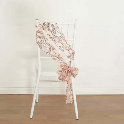 Pink floral ribbon tied in a bow on a white chair.