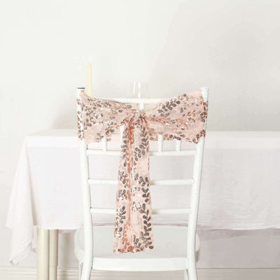 Blush pink sequin chair sash tied on a white chair