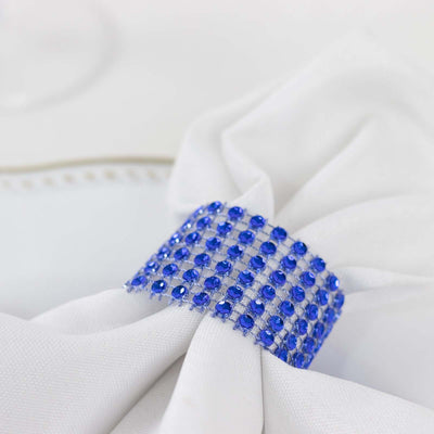 White napkin with blue rhinestone napkin ring.