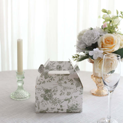 Floral patterned takeaway box on a table with a candle and flowers.