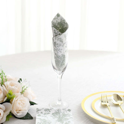 Elegant floral napkin in champagne flute on a beautifully set table.