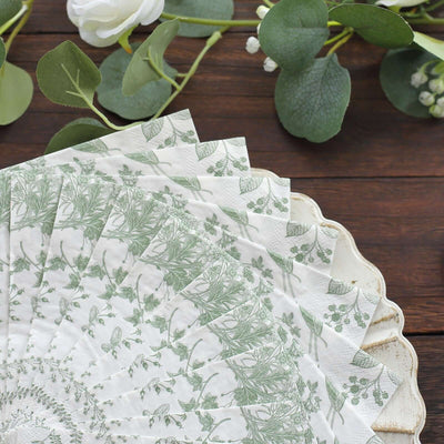 Decorative paper fan with botanical print on a wooden surface.