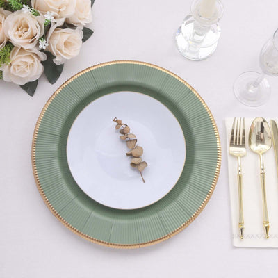 Elegant green and white plate setting with decorative leaf and floral arrangement.