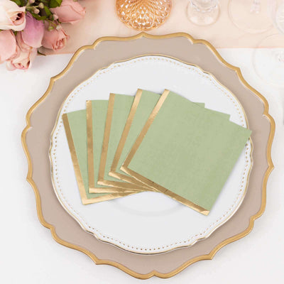 Green napkins with gold trim arranged on an elegant plate.