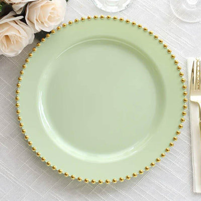 Mint green plate with gold beaded rim on a textured surface.