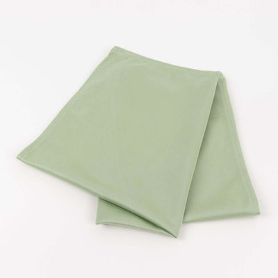 Green fabric napkins folded neatly on a white background