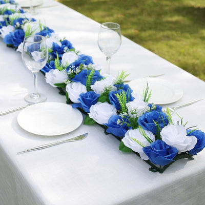 Blue and white floral table runner with plates and glasses set for outdoor dining.