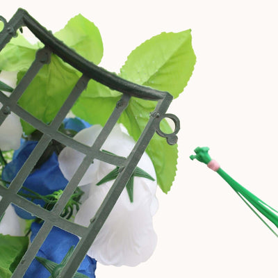Green plant support with white and blue flowers, studio shot