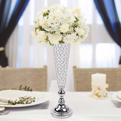 Elegant floral centerpiece in crystal vase for table decor.
